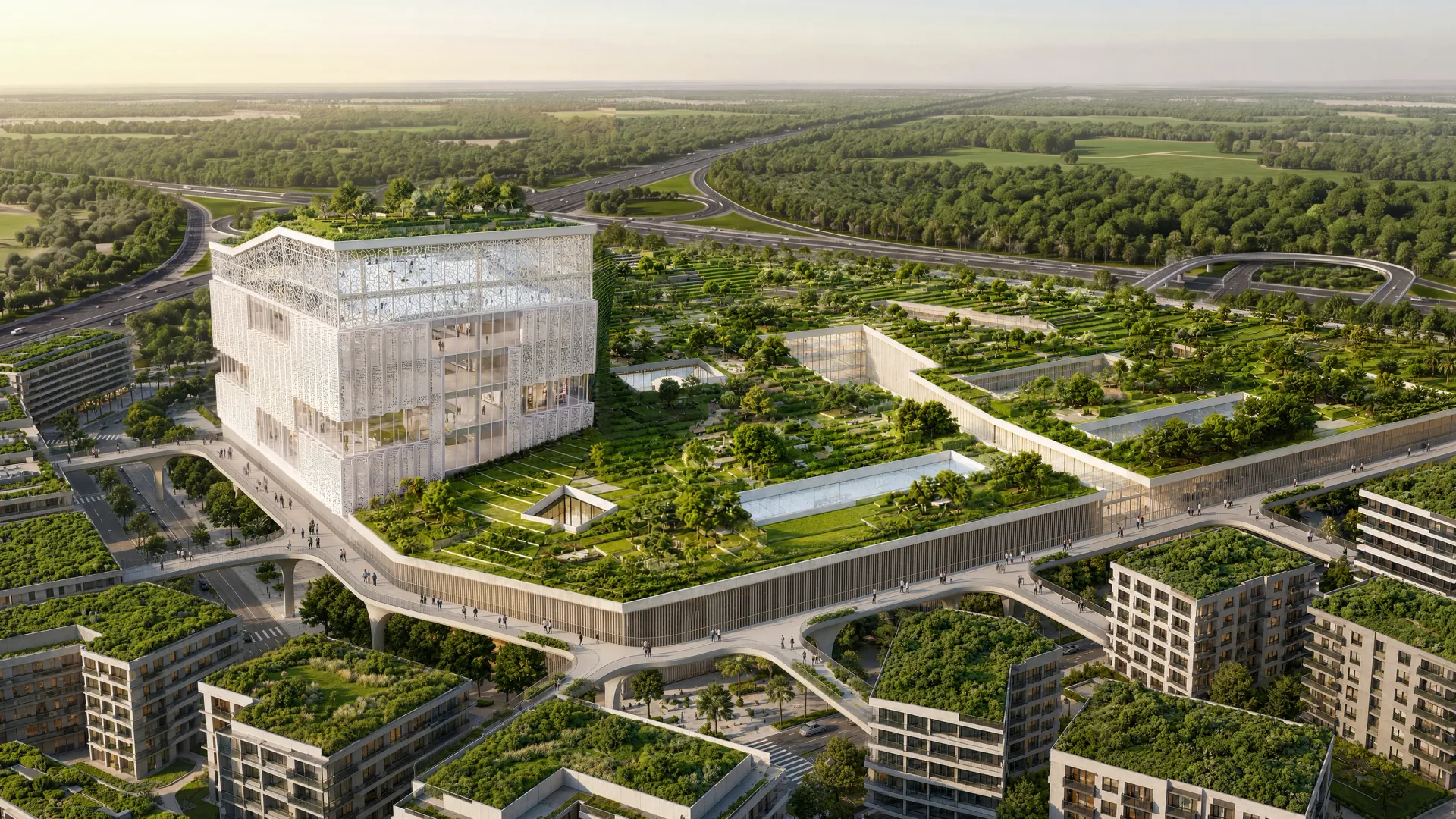 Aerial view of the landmark innovation hub at Abu Dhabi Mira Hills, a glazed cube above green terraces beside the highway